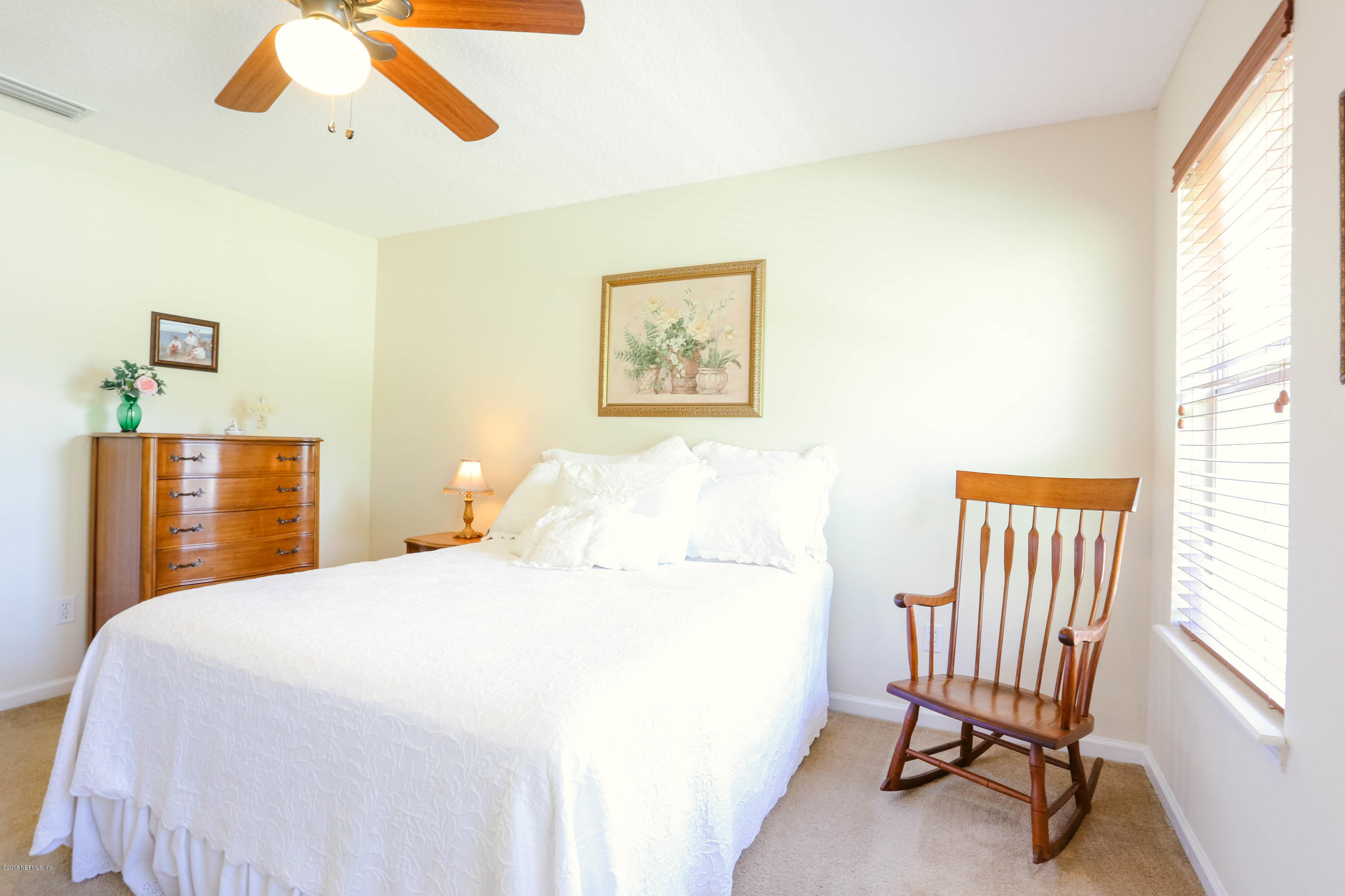 1205 Southern Stream Court Jacksonville, FL 32259 - Photo 22 of 42 a bedroom with a bed and a chandelier