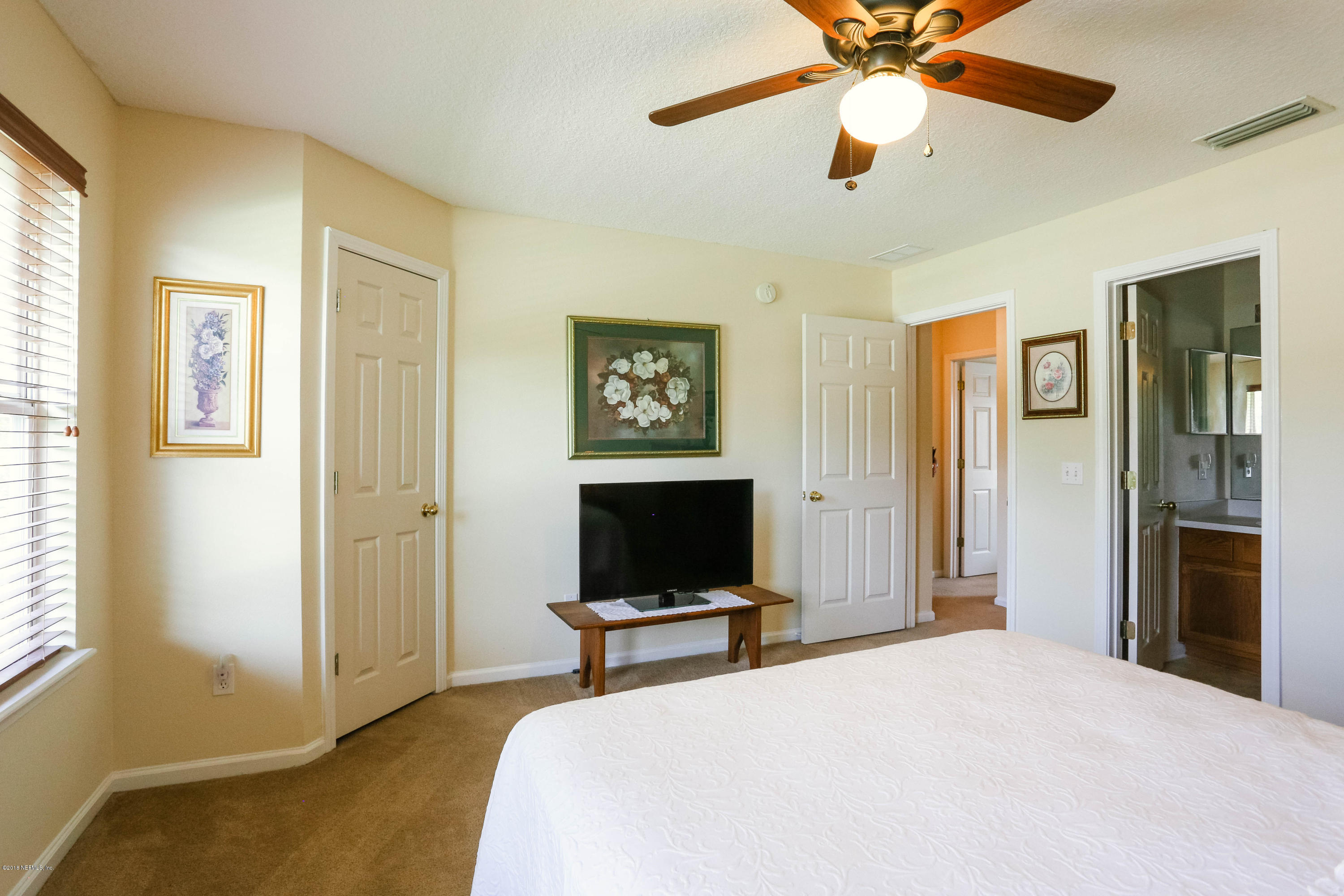 1205 Southern Stream Court Jacksonville, FL 32259 - Photo 23 of 42 a bedroom with a bed and a flat screen tv