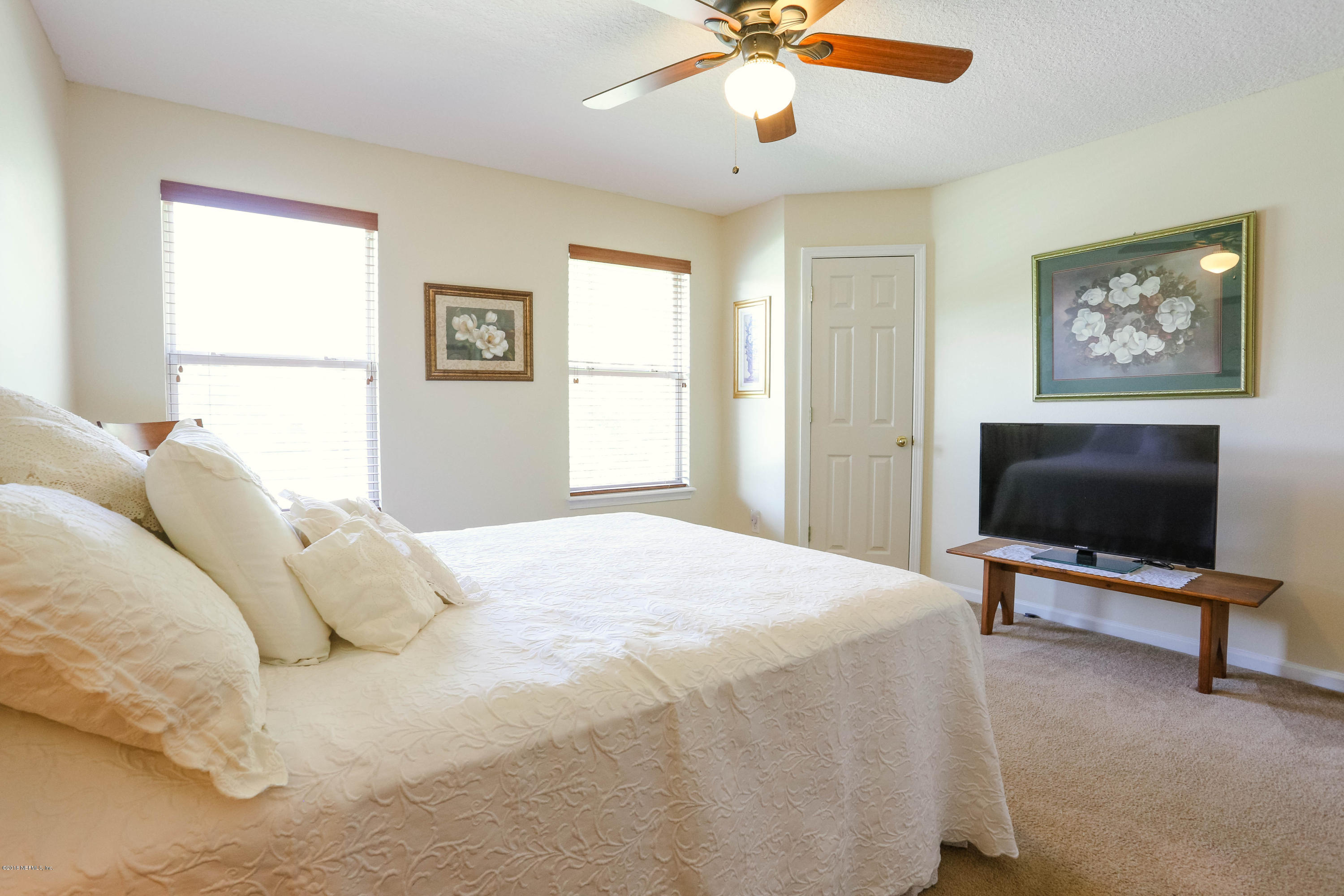 1205 Southern Stream Court Jacksonville, FL 32259 - Photo 24 of 42 a bedroom with a large bed and a flat screen tv