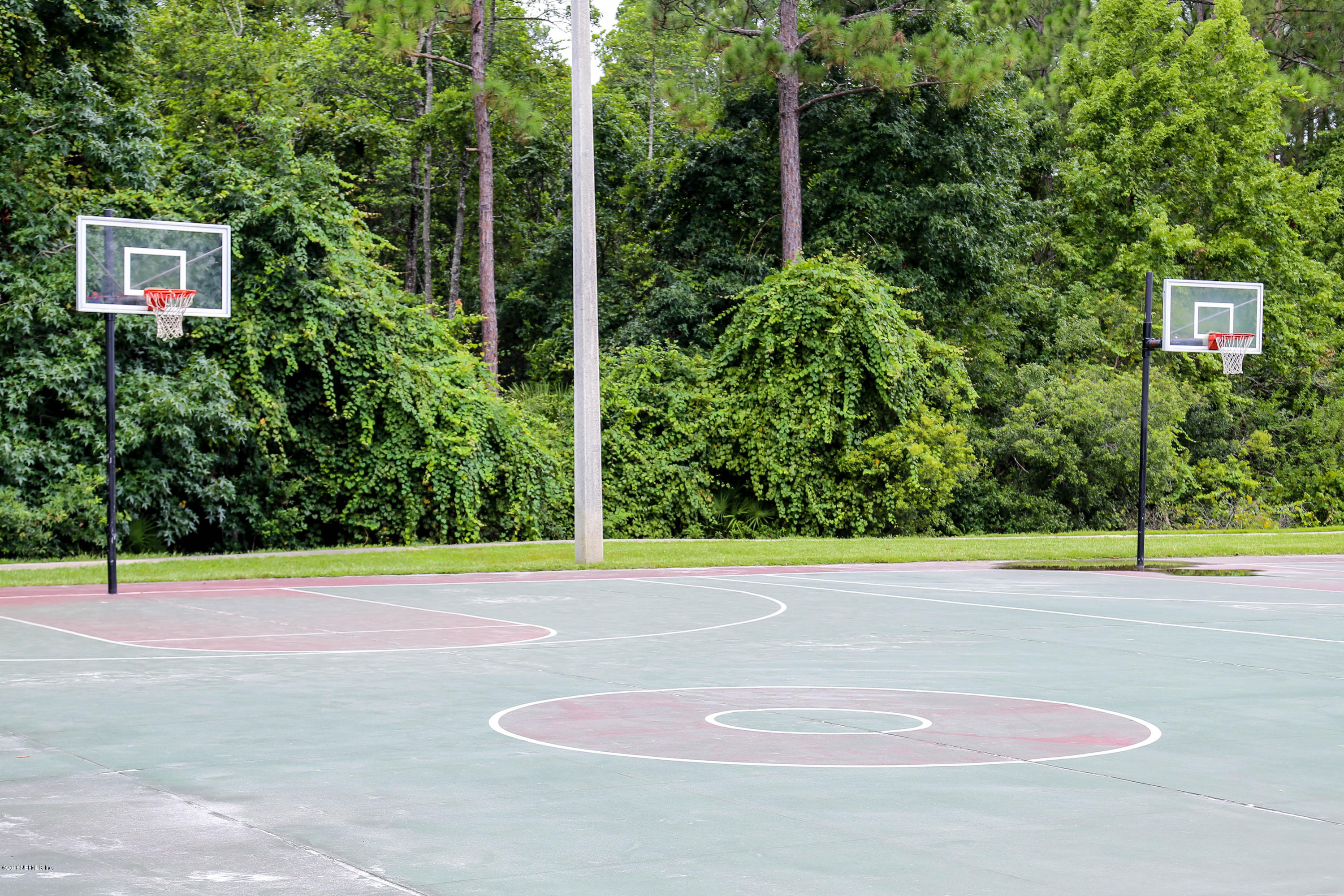 1205 Southern Stream Court Jacksonville, FL 32259 - Photo 38 of 42 a view of a tennis court with a small yard
