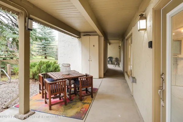 a view of a balcony with furniture and a yard