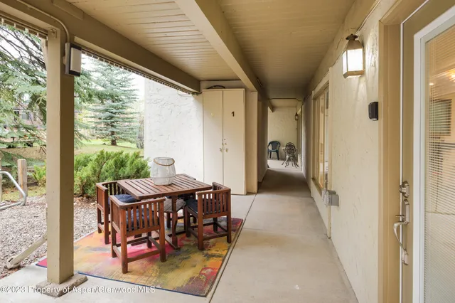 a view of a balcony with furniture and a yard