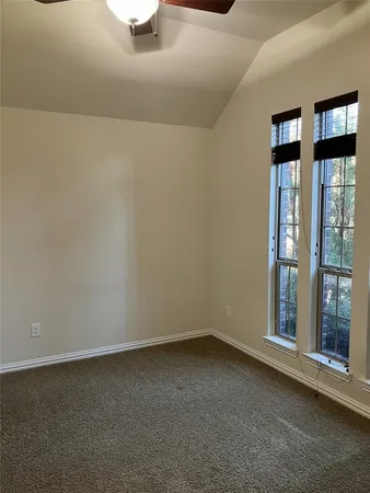 a view of a hallway with wooden floor and a living room