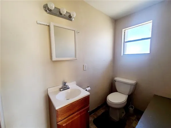 a bathroom with a toilet sink and mirror