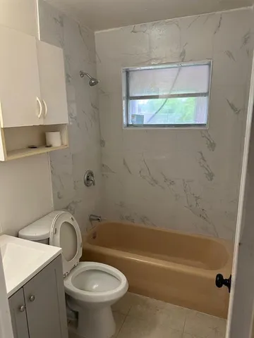 a bathroom with a sink a toilet and a bathtub