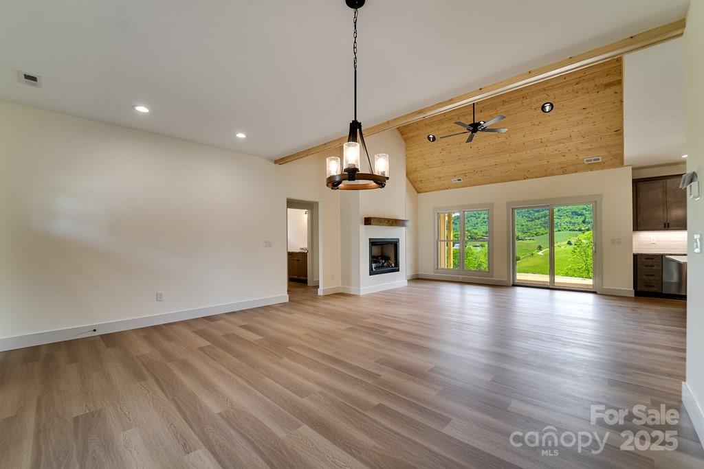 70 Knox Best Street Clyde, NC 28721 - Photo 13 of 33 a view of a room with window wooden floor and ceiling fan