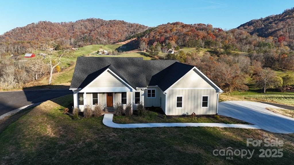 70 Knox Best Street Clyde, NC 28721 - Photo 2 of 33 a front view of a house with garden