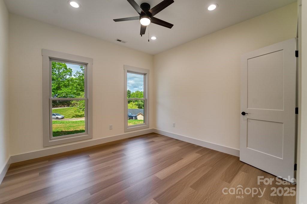 70 Knox Best Street Clyde, NC 28721 - Photo 23 of 33 a view of an empty room with a window and wooden floor