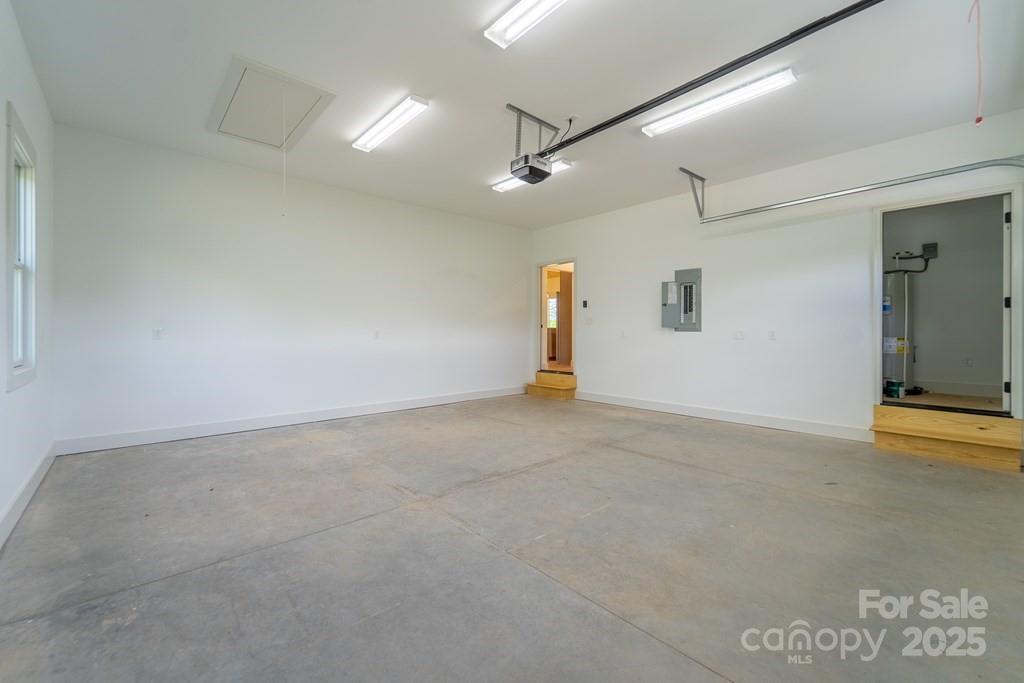 70 Knox Best Street Clyde, NC 28721 - Photo 30 of 33 en empty room with ceiling fan and windows