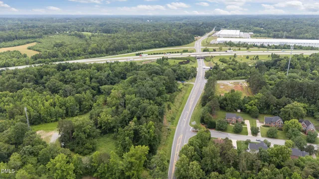 an aerial view of a house with a yard and lake view