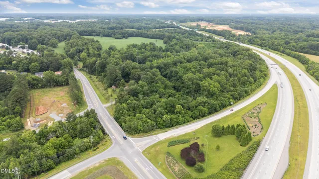 a view of a green field with lots of bushes