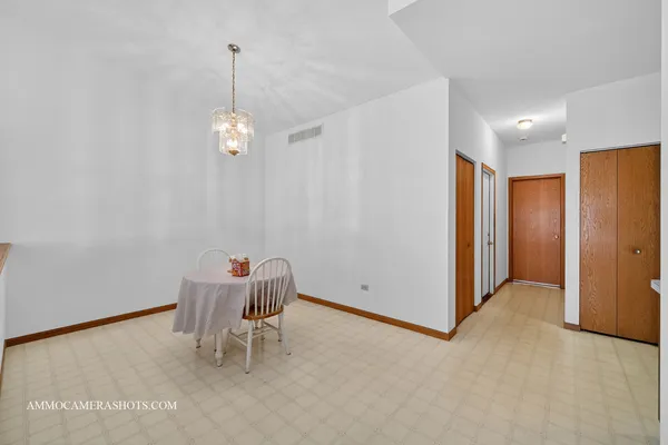 a view of a room with a chandelier fan and windows