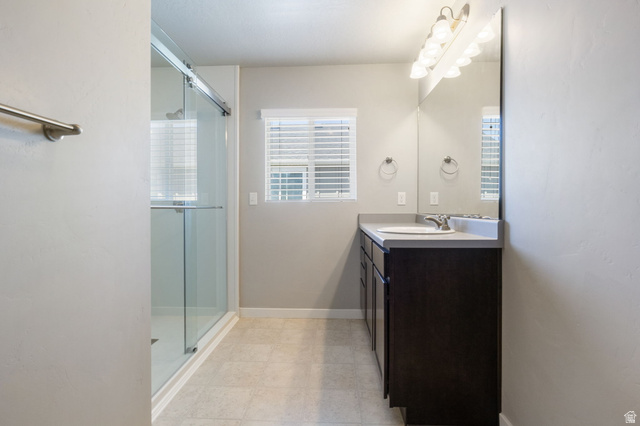 5155 East Rio Grande Way Eagle Mountain, UT 84005 - Photo 20 of 40 Full bath featuring vanity, light floors, and a stall shower