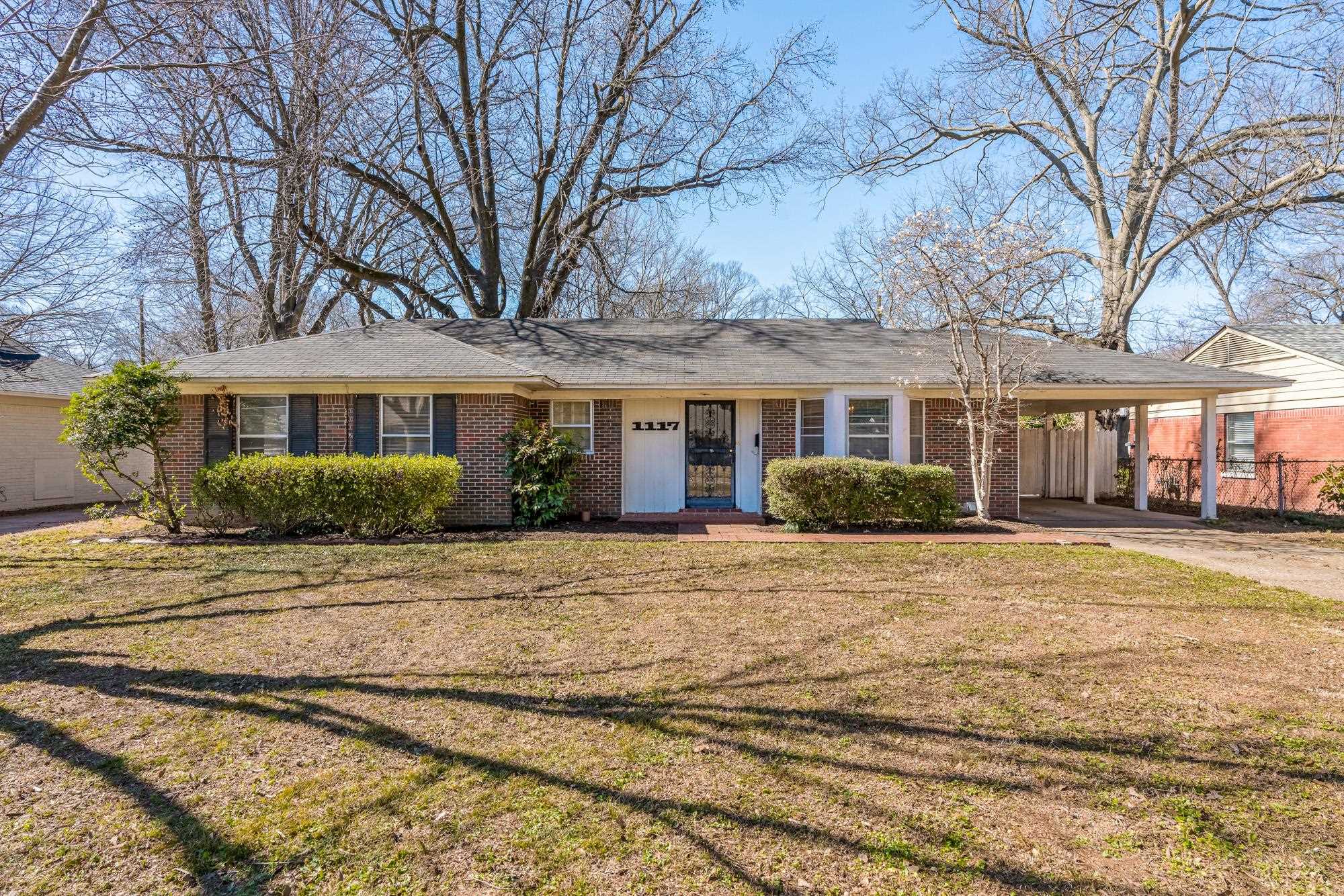 1117 South Perkins Road Memphis, TN 38117 - Photo 1 of 24 a front view of a house with a garden