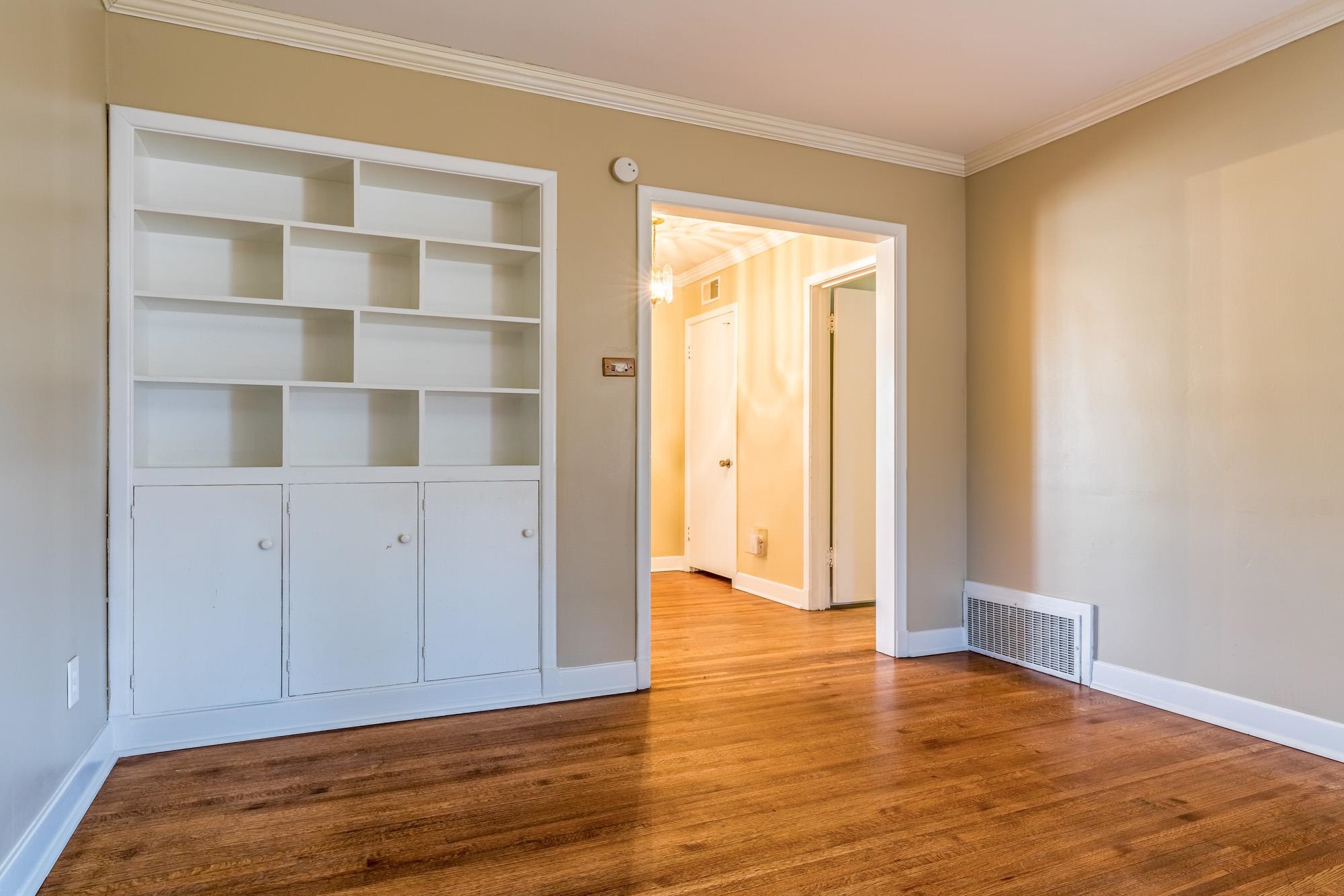 1117 South Perkins Road Memphis, TN 38117 - Photo 15 of 24 a view of an empty room with wooden floor and closet