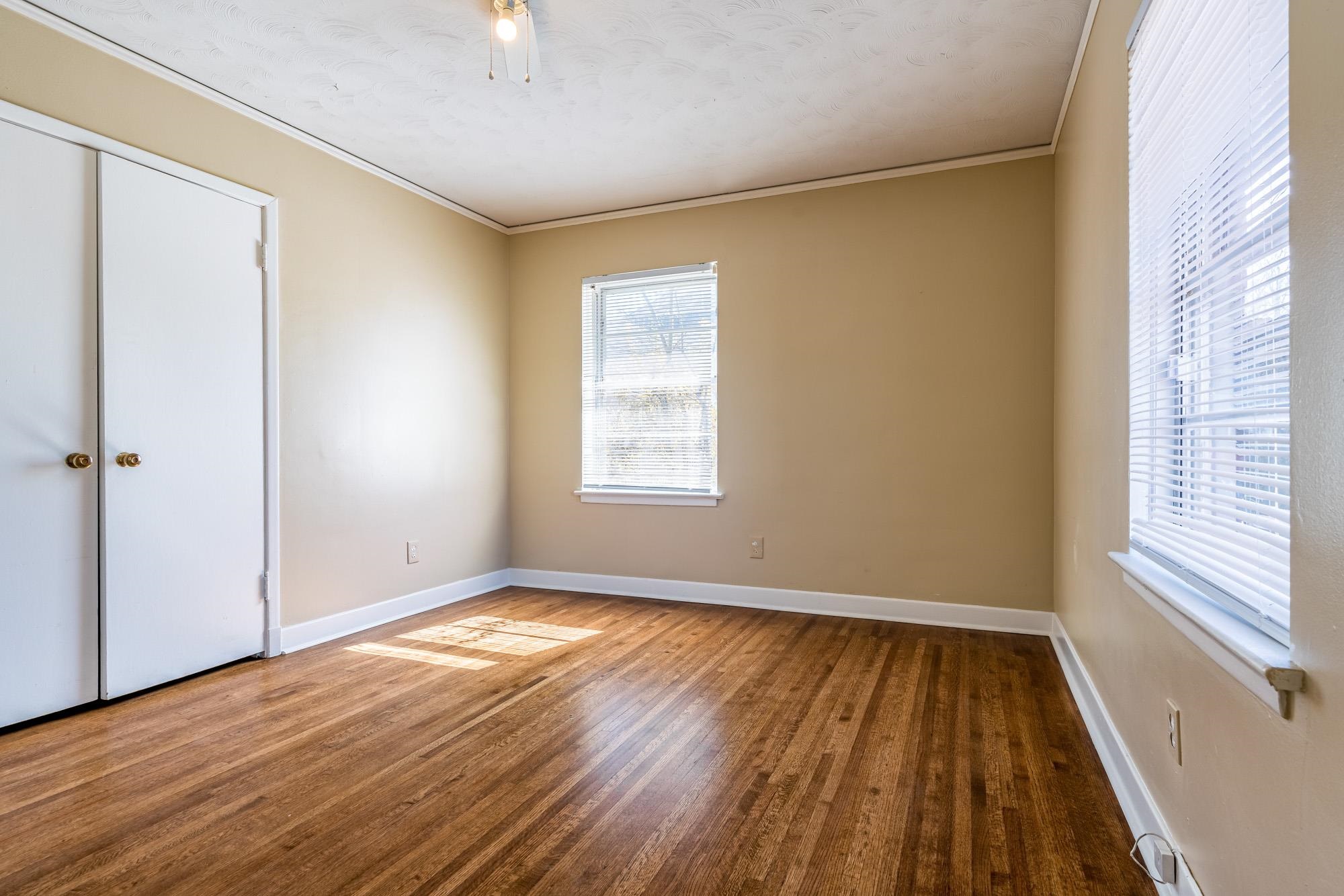 1117 South Perkins Road Memphis, TN 38117 - Photo 18 of 24 a view of an empty room with wooden floor and a window