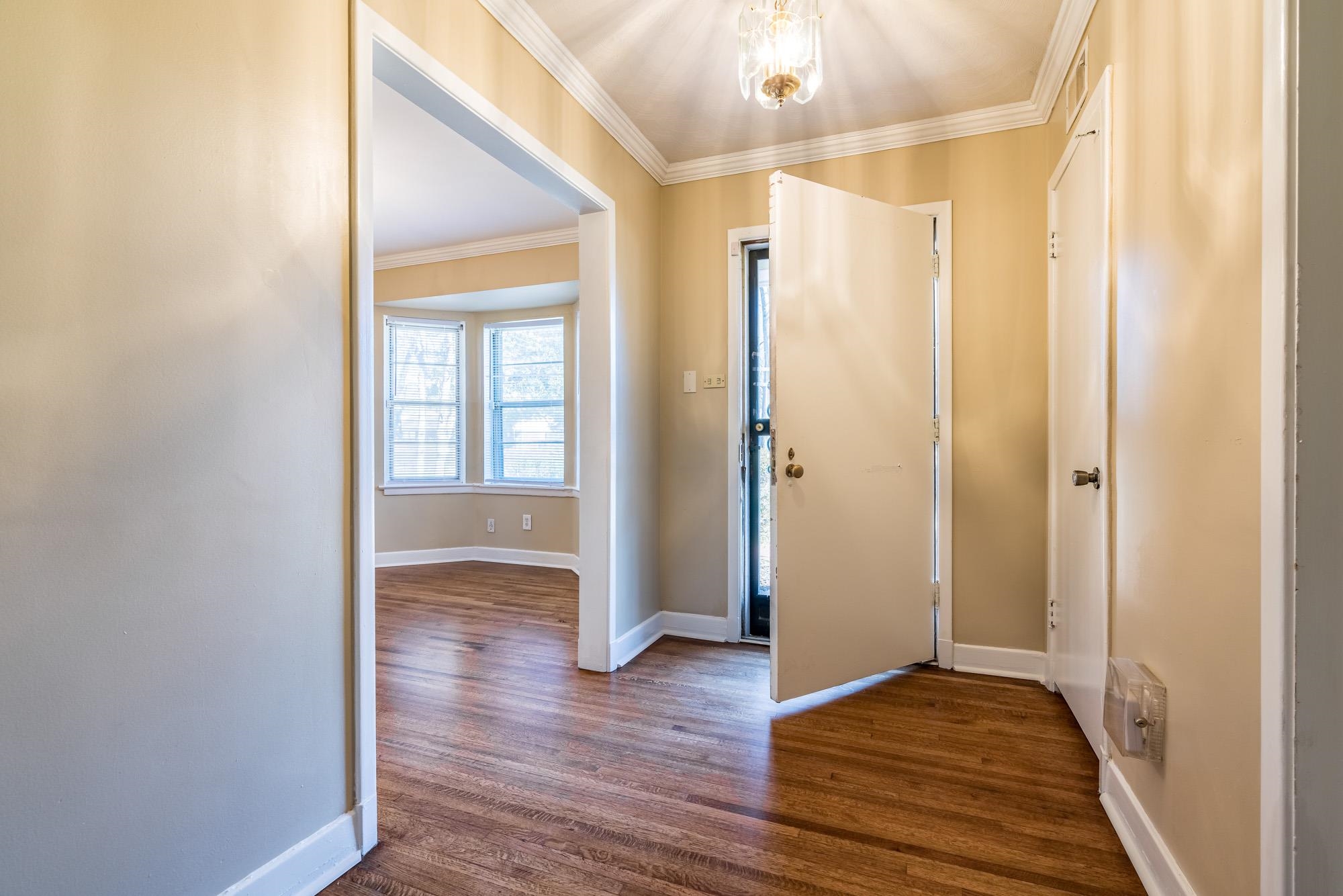 1117 South Perkins Road Memphis, TN 38117 - Photo 4 of 24 a view of an empty room with wooden floor and a window