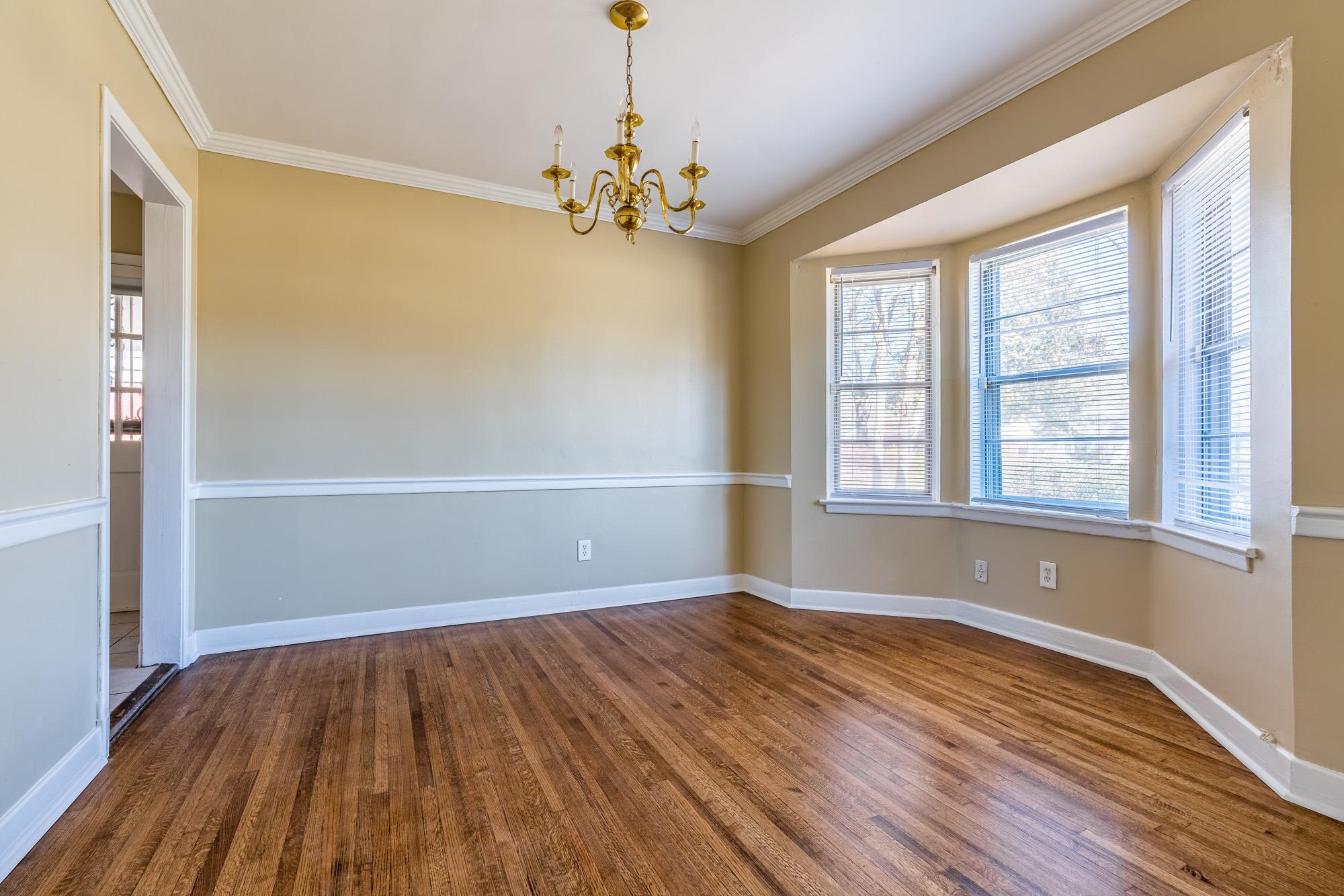 1117 South Perkins Road Memphis, TN 38117 - Photo 6 of 24 a view of empty room with wooden floor and fan