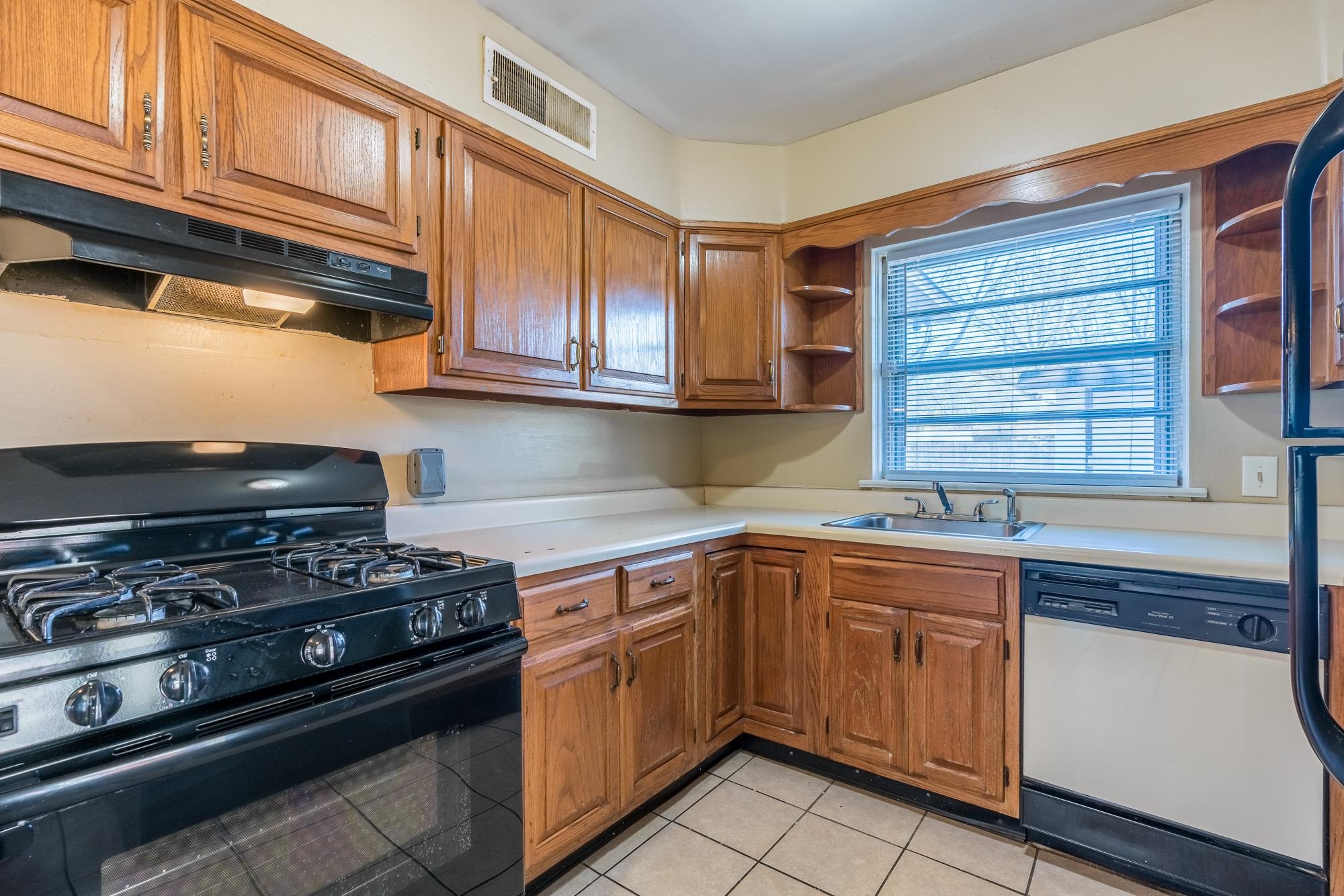 1117 South Perkins Road Memphis, TN 38117 - Photo 10 of 24 a kitchen with stainless steel appliances granite countertop a stove sink and cabinets