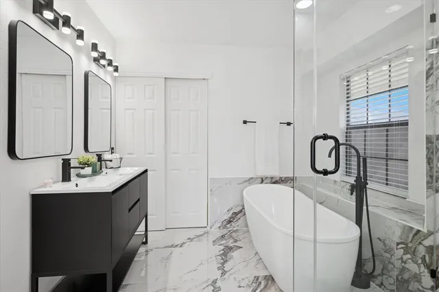 a en suite bathroom with a double vanity sink a and a mirror