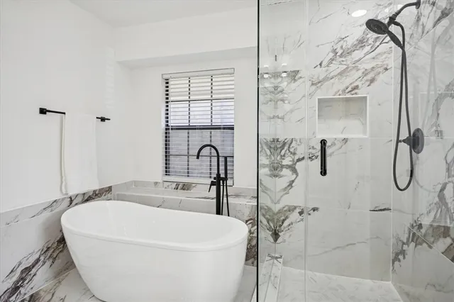a bathroom with a bathtub and shower