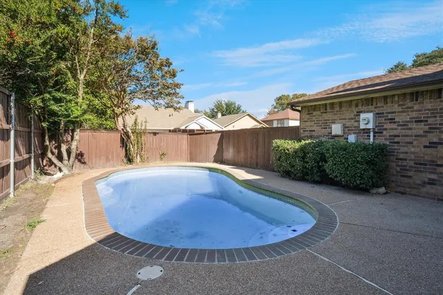 a view of a swimming pool with an outdoor space and seating area