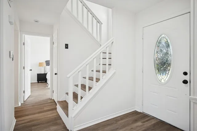 a view of entryway with wooden floor and stairs