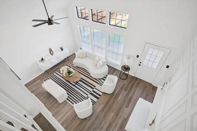 a view of living room with furniture and wooden floor