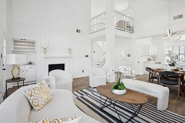 a living room with furniture a fireplace and a table