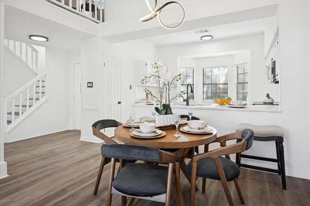 a dining room with furniture and wooden floor
