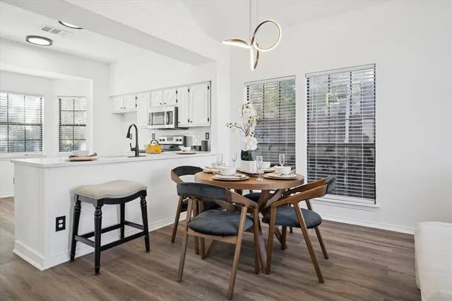 a dining room with furniture and wooden floor