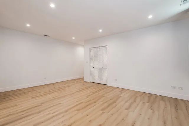 an empty room with wooden floor