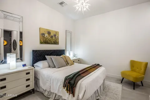 a bathroom with a granite countertop sink a toilet a mirror a vanity a bath tub and shower