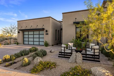 a view of a house with backyard and sitting area