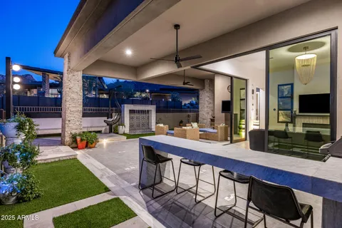 a living room with furniture a lamp and a potted plant