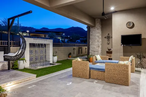 a living room with furniture a chandelier and a fireplace
