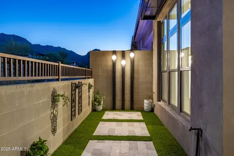 a view of the patio with couches and a fireplace