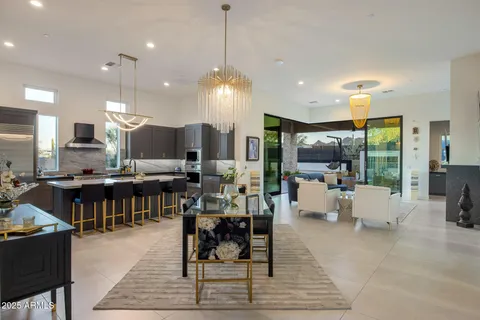 a living room with furniture fireplace and a large window
