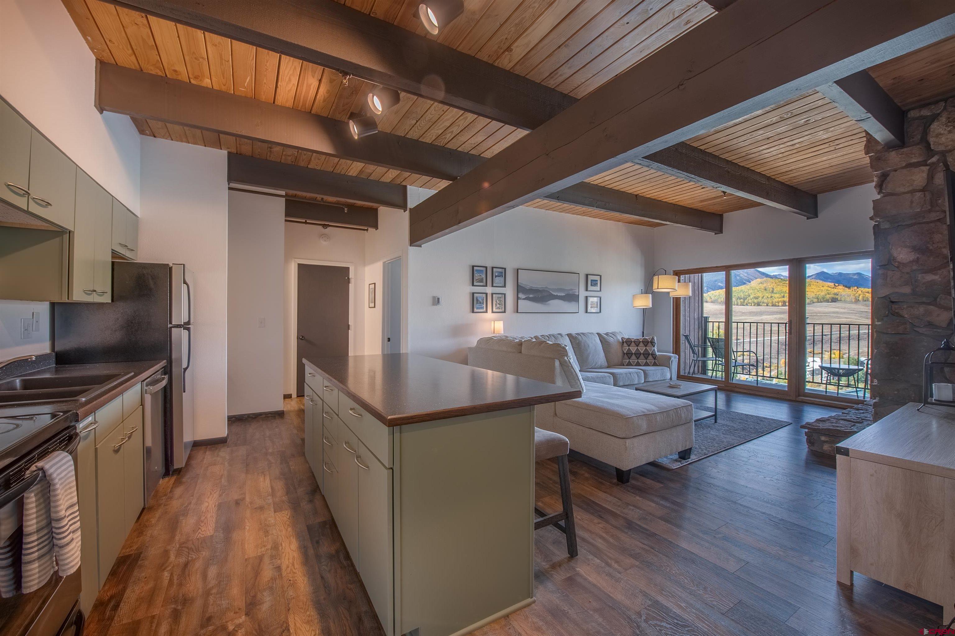 a kitchen with sink stove and refrigerator