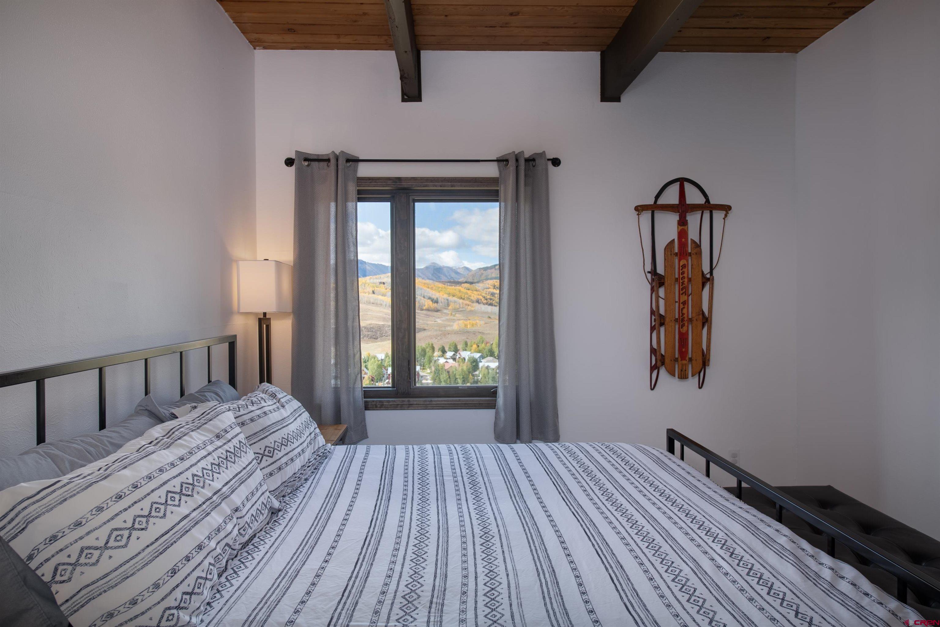 32 Hunter Hill Road, Unit B102 Crested Butte, CO 81225 - Photo 16 of 28 a bedroom with a bed and a window
