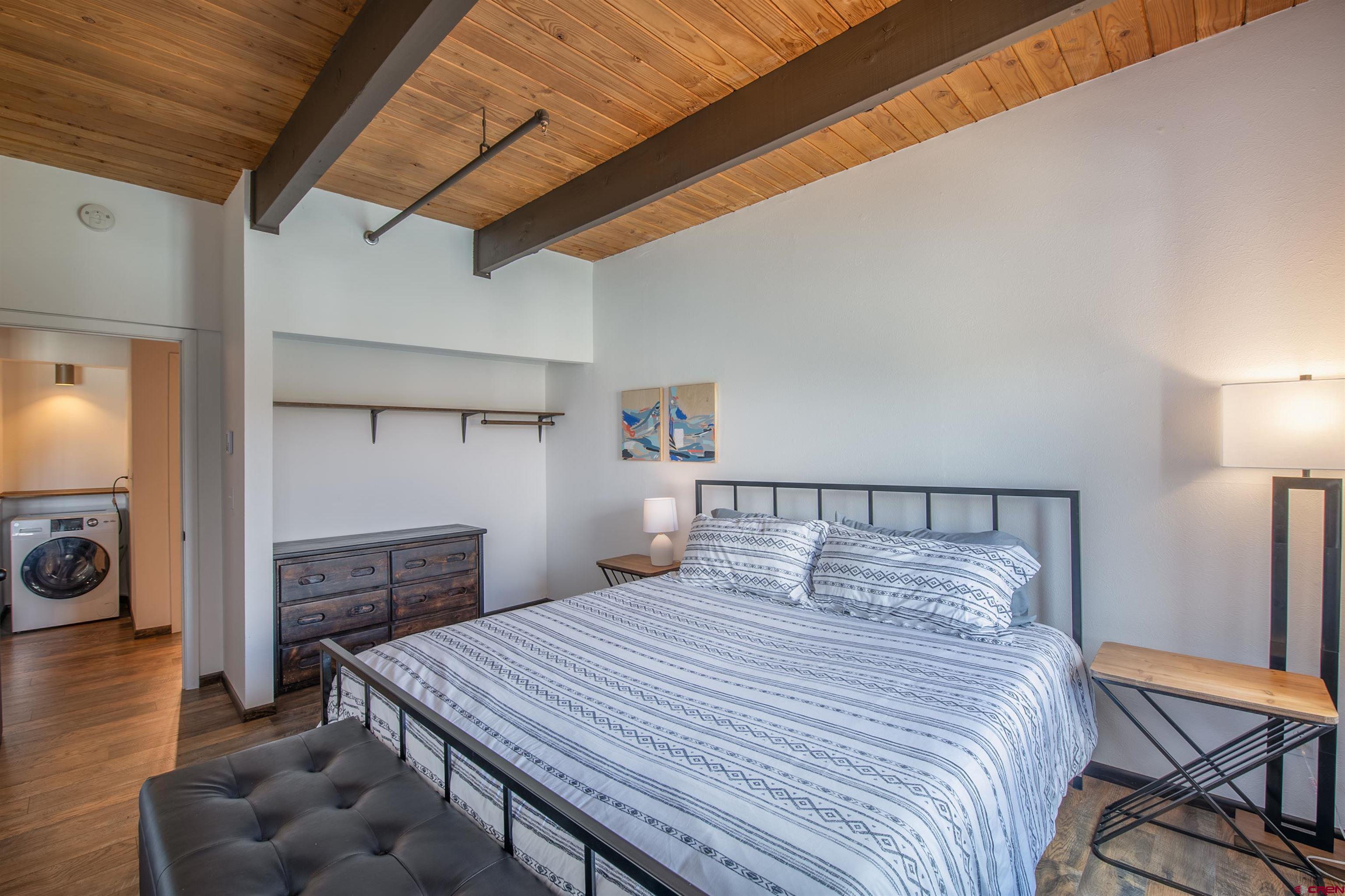 32 Hunter Hill Road, Unit B102 Crested Butte, CO 81225 - Photo 17 of 28 a bedroom with a bed and a tv on table