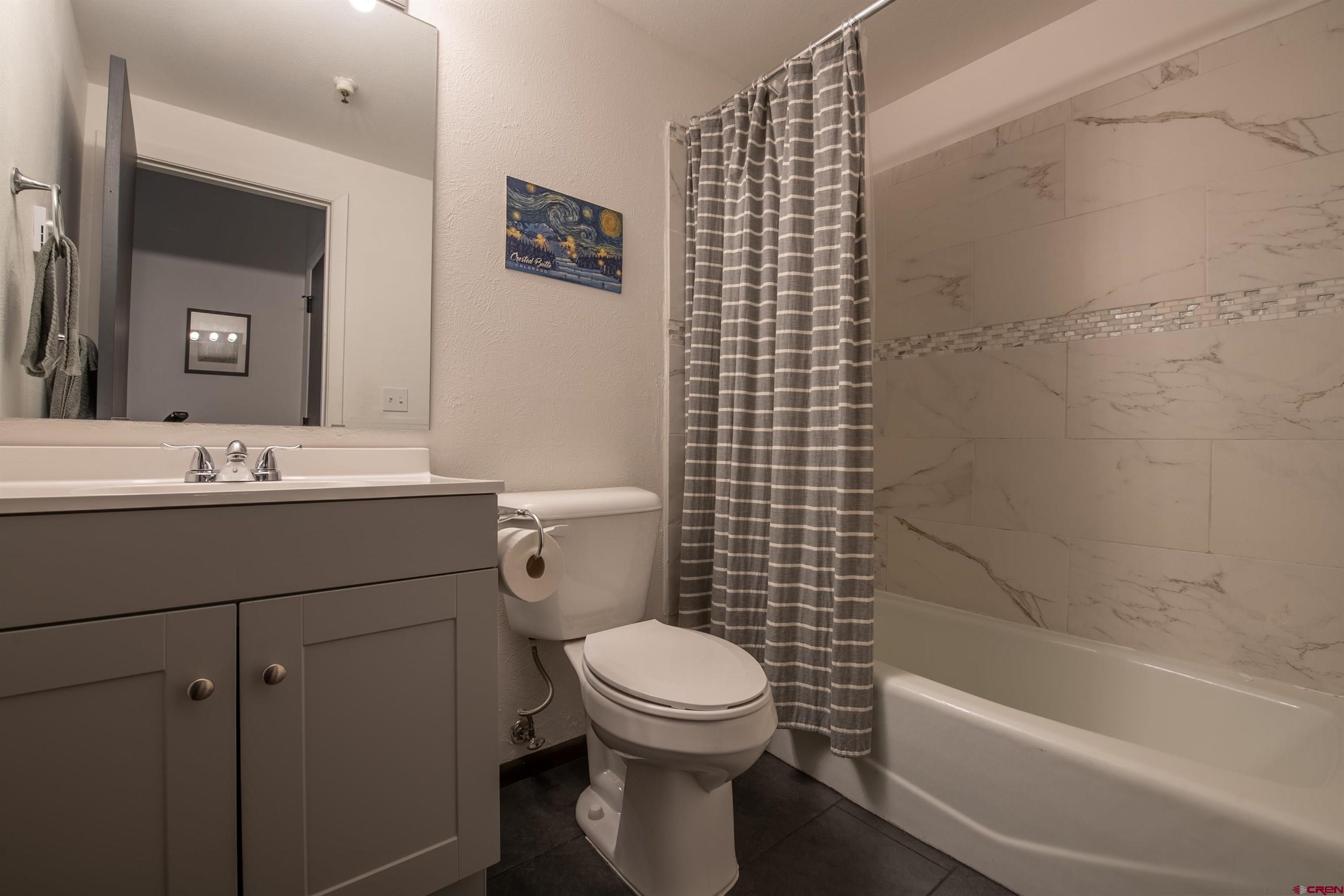 32 Hunter Hill Road, Unit B102 Crested Butte, CO 81225 - Photo 18 of 28 a bathroom with a sink a toilet and a bathtub