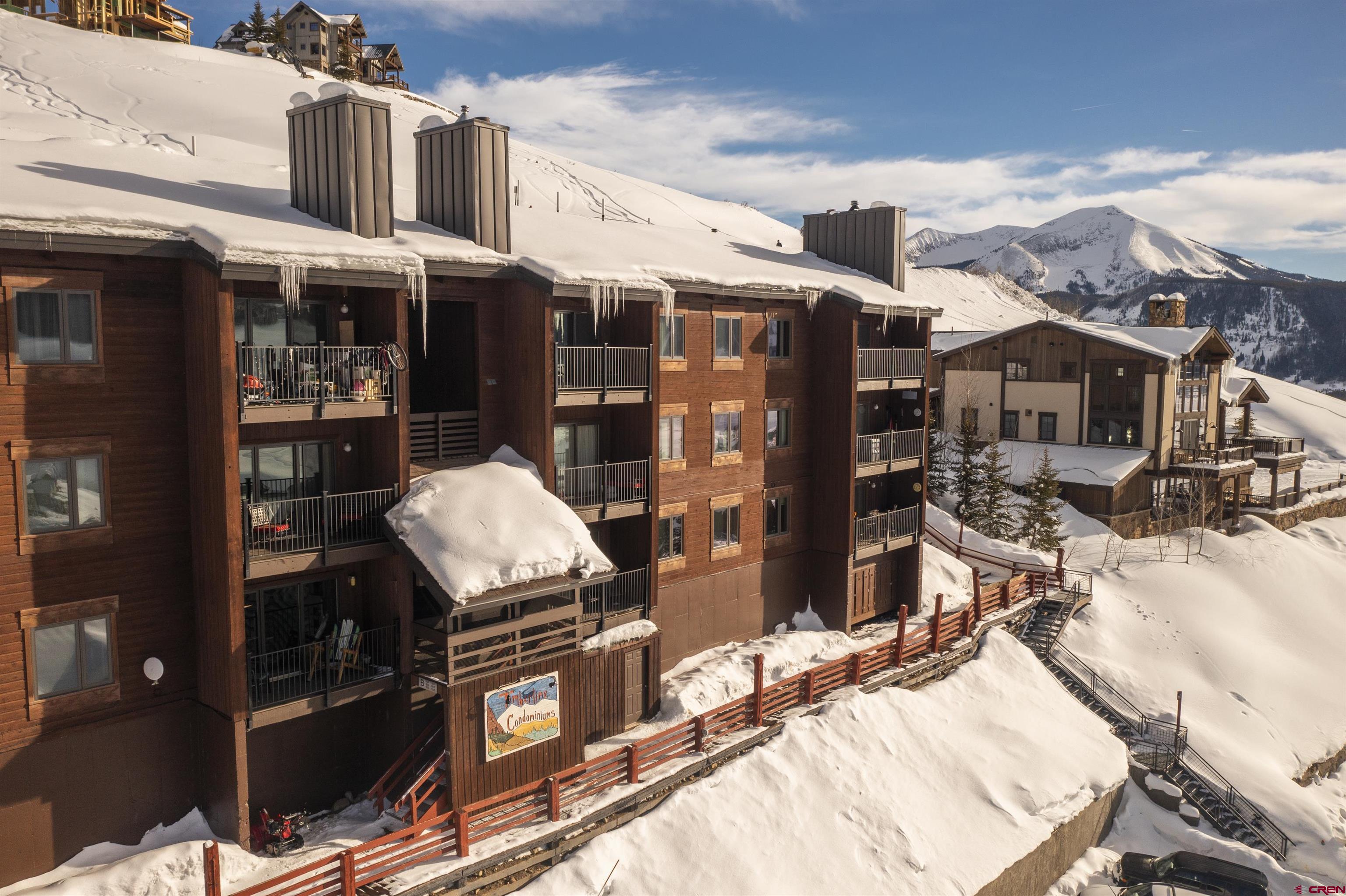 32 Hunter Hill Road, Unit B102 Crested Butte, CO 81225 - Photo 27 of 28 a view of a patio with wooden chairs