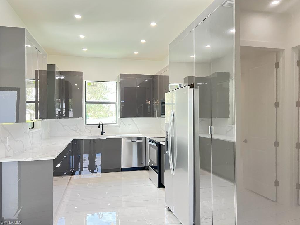 3302 East 3rd Street Lehigh Acres, FL 33936 - Photo 14 of 23 a large bathroom with a large tub and sink