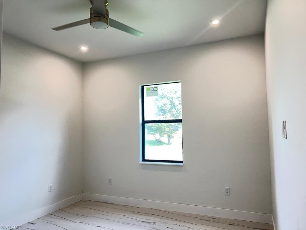 3302 East 3rd Street Lehigh Acres, FL 33936 - Photo 16 of 23 an empty room with a window