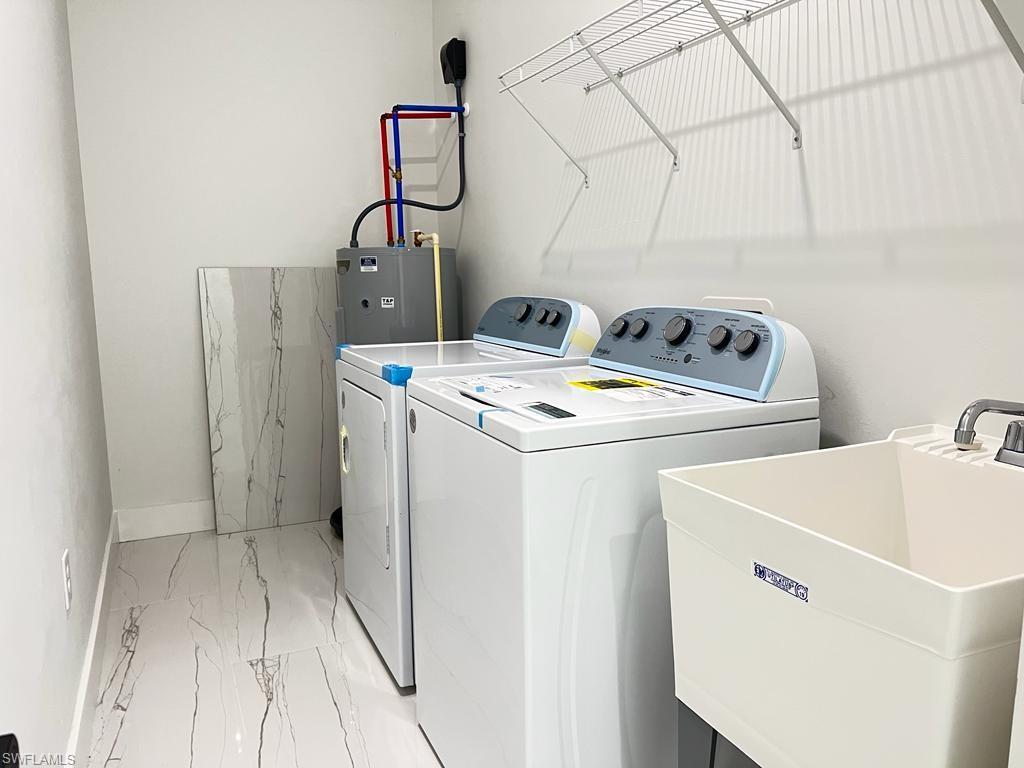 3302 East 3rd Street Lehigh Acres, FL 33936 - Photo 4 of 23 a utility room with dryer and washer