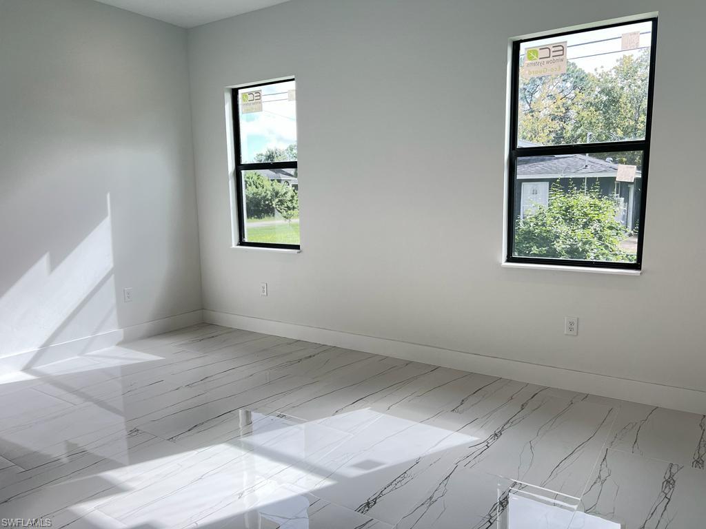 3302 East 3rd Street Lehigh Acres, FL 33936 - Photo 6 of 23 an empty room with windows
