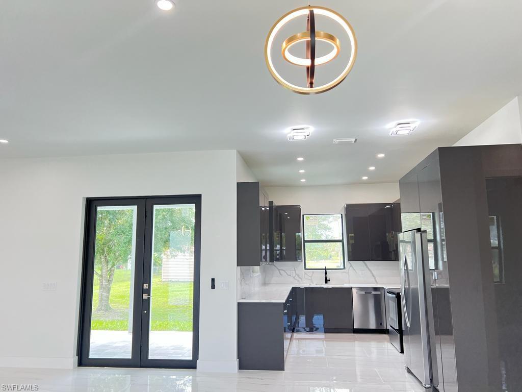 3302 East 3rd Street Lehigh Acres, FL 33936 - Photo 10 of 23 a view of a living room and kitchen