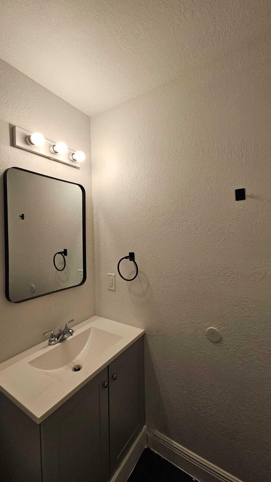 3391 Avenue South Riviera Beach, FL 33404 - Photo 14 of 16 a bathroom with a sink and mirror
