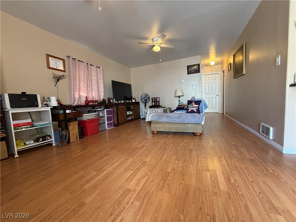 645 Murry Street Ely, NV 89301 - Photo 5 of 16 Bedroom featuring ceiling fan, wood finished floors, visible vents, and baseboards